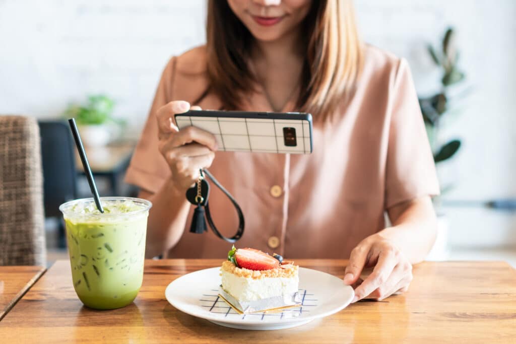 woman taking photo of food