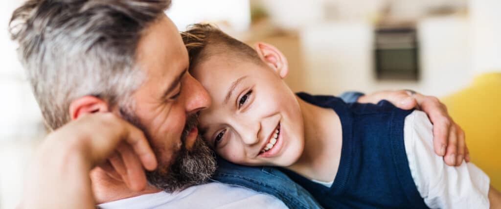 father and son hugging and smiling