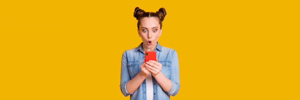 teen girl with shocked face looking at cell phone